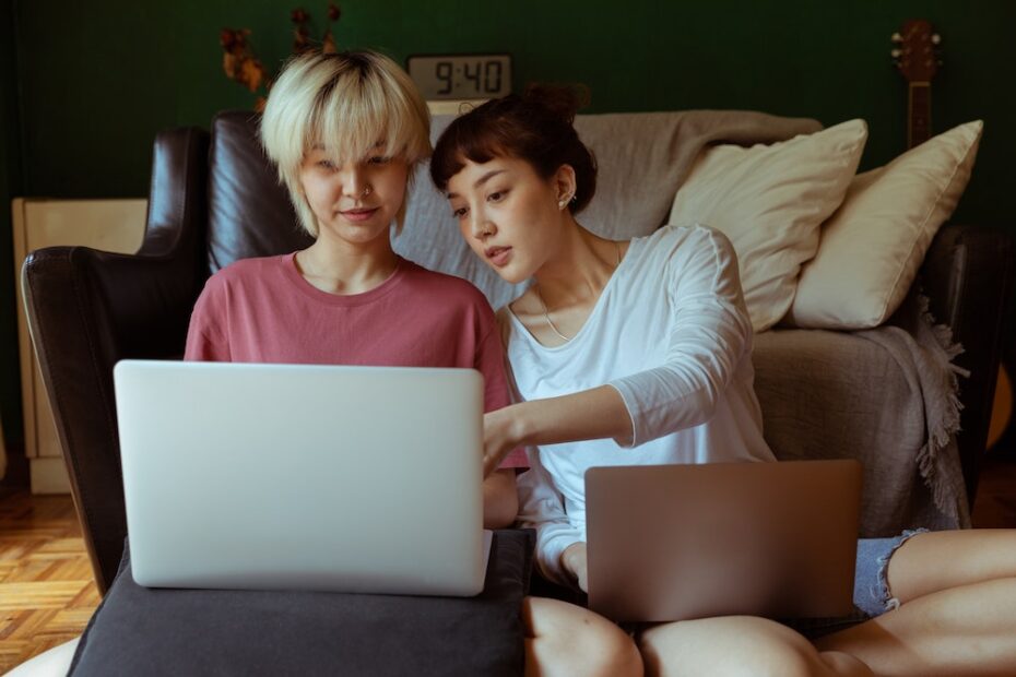 Two women using laptop