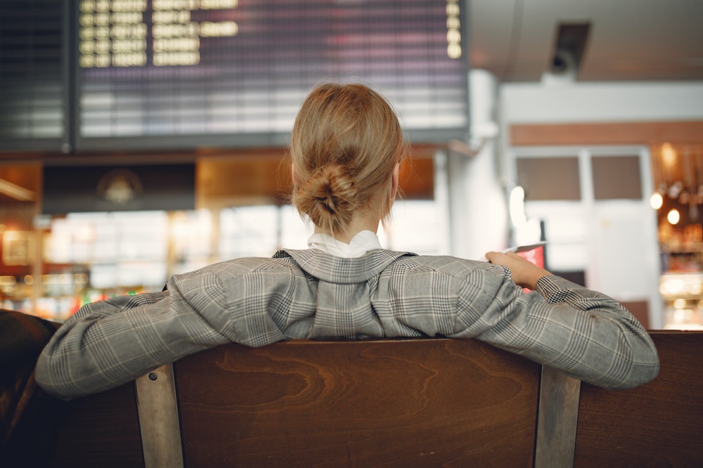 A young woman waiting at an airport