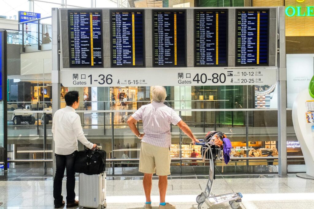 People looking at departured board at an airport