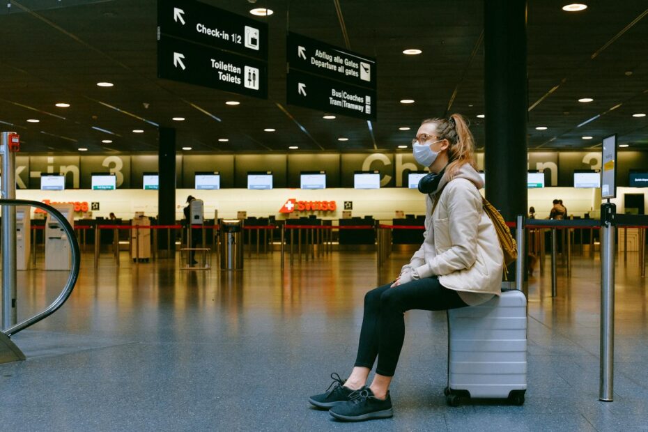 Woman sitting on a suitcase